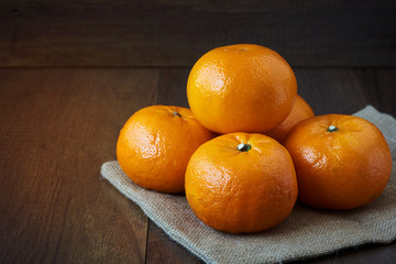 Tasty mandarin oranges on wooden background
