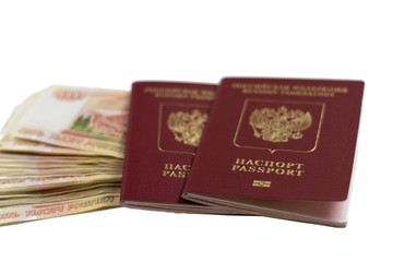 Two Russian foreign passports with a bundle of money. Immigration or tourism concept. Denominations of five thousand rubles 5,000 red on a white isolated background...