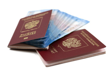 Two Russian foreign passports with a bundle of money. Immigration or tourism concept. Banknotes with a face value of two thousand rubles 2000 blue on a white isolated background...