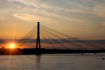 Riga, Latvia. Vansu suspension bridge over the Daugava River in the evening..