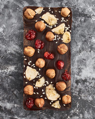 Handmade chocolate bar filled with cherries, bananas, sesame seeds and nuts.