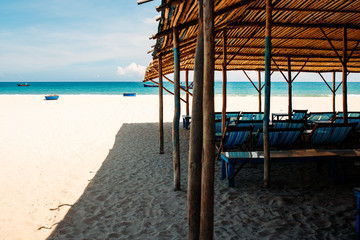 Obraz na płótnie Canvas Chair on a sandy beach by the sea