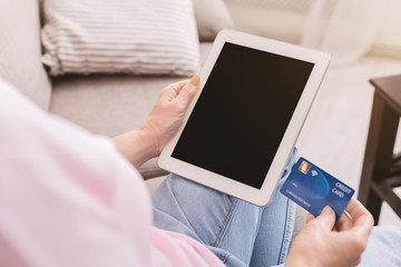 Retired lady buying goods online on digital tablet