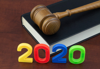 Wooden judge gavel with legal book and numbers 2020. Concept new laws in year 2020.