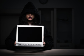 Female hacker hacking security firewall late in office