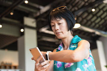 woman using smartphone with smart watch