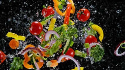 Fresh vegetables with water droplets exploding on black background. Filmed on high speed cinema camera, 1000fps. - Powered by Adobe