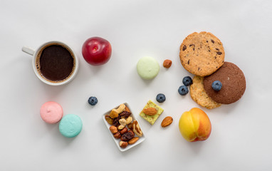 Sweets, fruits and berries on white background for coffee
