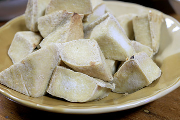 Home made of snack and dessert, Chinese Traditional Deep Fried Tofu or Fried Bean Curd Served in dish on wooden table.