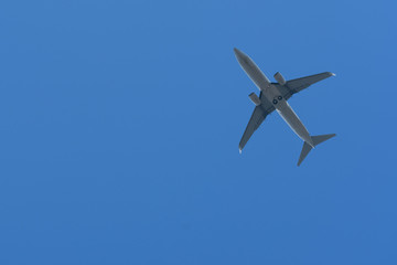 Fototapeta premium Bottom View of the Airplane in the sky with blank copy space for travel comcept
