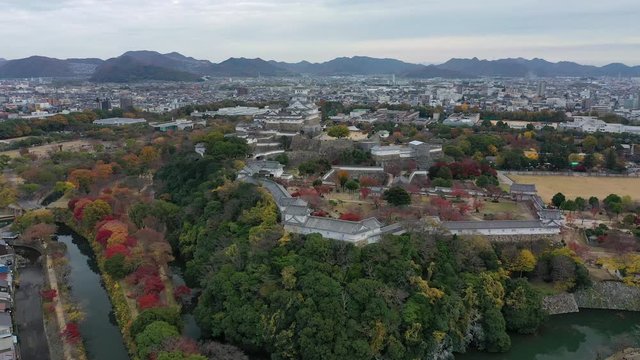 Aerial view of famous Himaji Castle, picturesque autumn scenery with medieval fortress complex and trees of many colors - landscape panorama of Japan from above, Asia