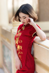 Portrait beautiful asian woman in Cheongsam dress,Thailand people,Happy Chinese new year concept,Happy  asian lady in chinese traditional dress