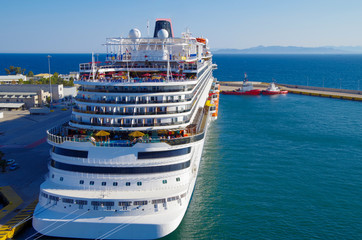 Gigantic modern cruise ship liner or cruiseship  in the port of Piraeus with the skyline of Athens...