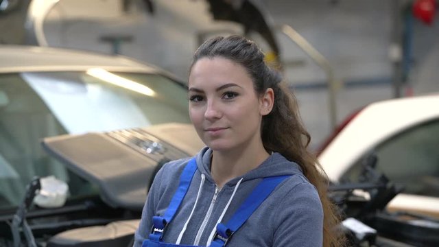 Portrait of apprentice standing in mechanics workshop