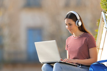 Student with laptop and headphones elearning