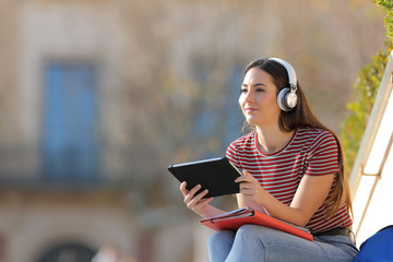 Student with headphones and tablet elearning