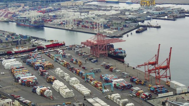 Aerial time lapse footage of a cargo ship being unloaded at a Seattle port