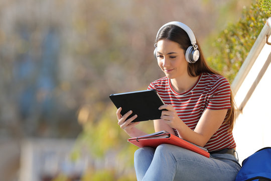 Serious Student E-learning With Tablet And Headphones