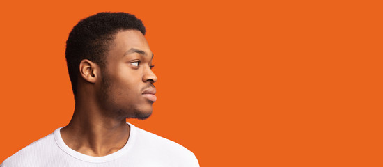 Side portrait of masculine afro guy looking at copyspace