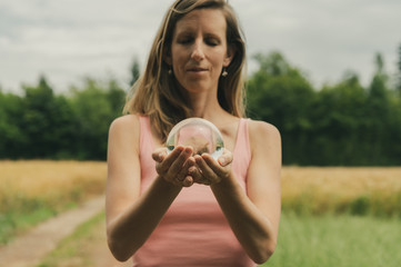 Young woman holding crystal ball
