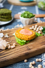 Vegan chickpea burgers cutlets or patties with sauce. Healthy vegan diet food.