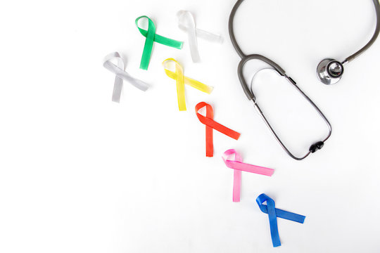 Flat layout of colorful ribbons beside a stethoscope