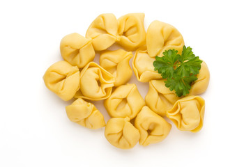 Raw homemade pasta,tortellini with herbs.