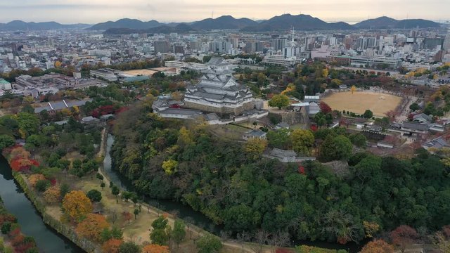 Aerial view of famous Himaji Castle, picturesque autumn scenery with medieval fortress complex and trees of many colors - landscape panorama of Japan from above, Asia