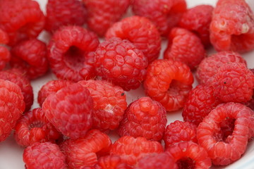 Raw and fresh raspberry on a white isolated background