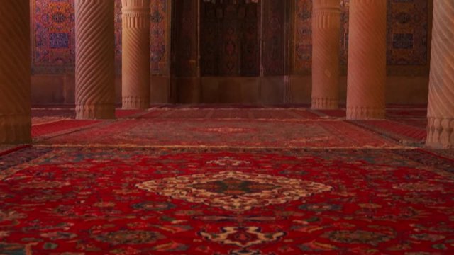 Tilting up | Beautiful interior with Persian carpet, decorated pillars, traditional mihrab and dome decorated with Islamic pattern inside Nasir Al Mulk mosque in Shiraz, Southern Iran | Silk Road Iran