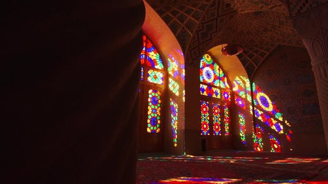 Sliding right | A revealing shot of the interior of Nasir Al Mulk mosque with it's swirling pillars in Shiraz, Southern Iran | Silk Road Iran