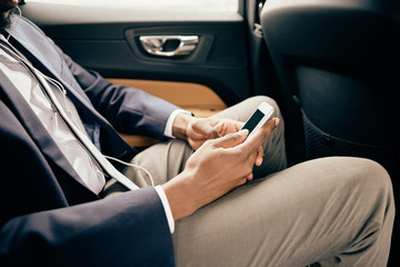 Close up of a man working on his phone in car.