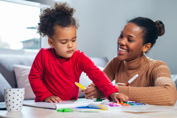 Happy family. Mother and daughter together paint.