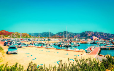 Old Sardinian Port and marina with ships at Mediterranean Sea in city of Villasimius in South Sardinia Island Italy in summer. Cityscape with Yachts and boats