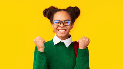 Cheering black school girl celebrating her triumph