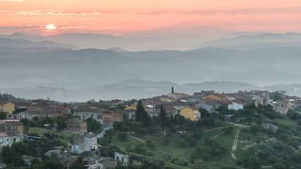 Sunrise over a village on a hill in sicily, italy