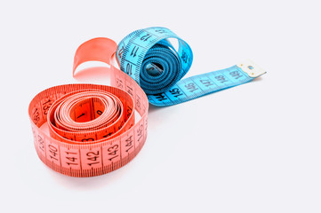 centimeter ribbon pink and blue on a white background. The concept of weight loss and a healthy...