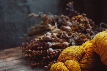 Obraz na płótnie Canvas Bright yellow wool yarn skeins in rustic background