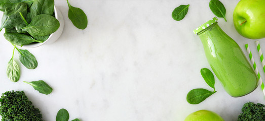 Banner with healthy green smoothie double border. Above view in milk bottle over a white marble background. Copy space.