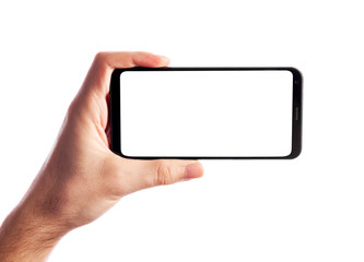Man holding smartphone with empty screen isolated on white background. Male hand with phone, space for text