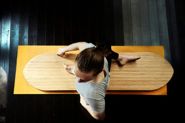 young man practicing yoga on a yoga board.