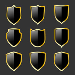 Black and gold shields set. Protection emblems. Security symbols