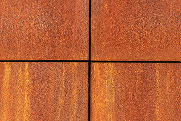 Rusted metal plates with crosswise border lines divided into four equal parts. Iron corroded...