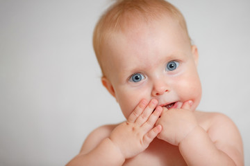 Cute Teething Infant Hold Fingers By Mouth Closeup