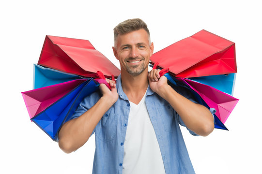 avid shopaholic. happy man with packages after shopping. handsome man care heavy shopping bags. buy gifts and presents. Thanks for your purchase. Shopping happiness. male shopper isolated on white