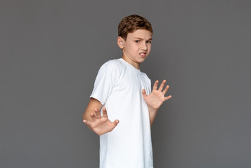 Teenage boy feeling disgust, pulling back from camera