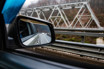 reflection of car traffic in the rearview mirror