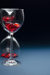 Valentine's day concept, Love concept, Wine glass for a wine filled with hearts on a blue background. Back light. Soft blurred focus