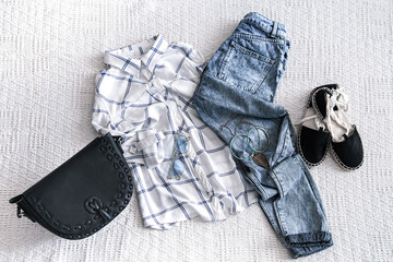 Set with fashionable women's clothing, shirt, jeans, and bag .Trendy hipster look. Flat lay.