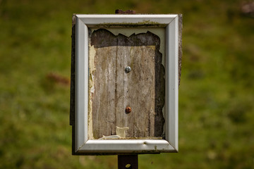 An empty signpost with blurry background